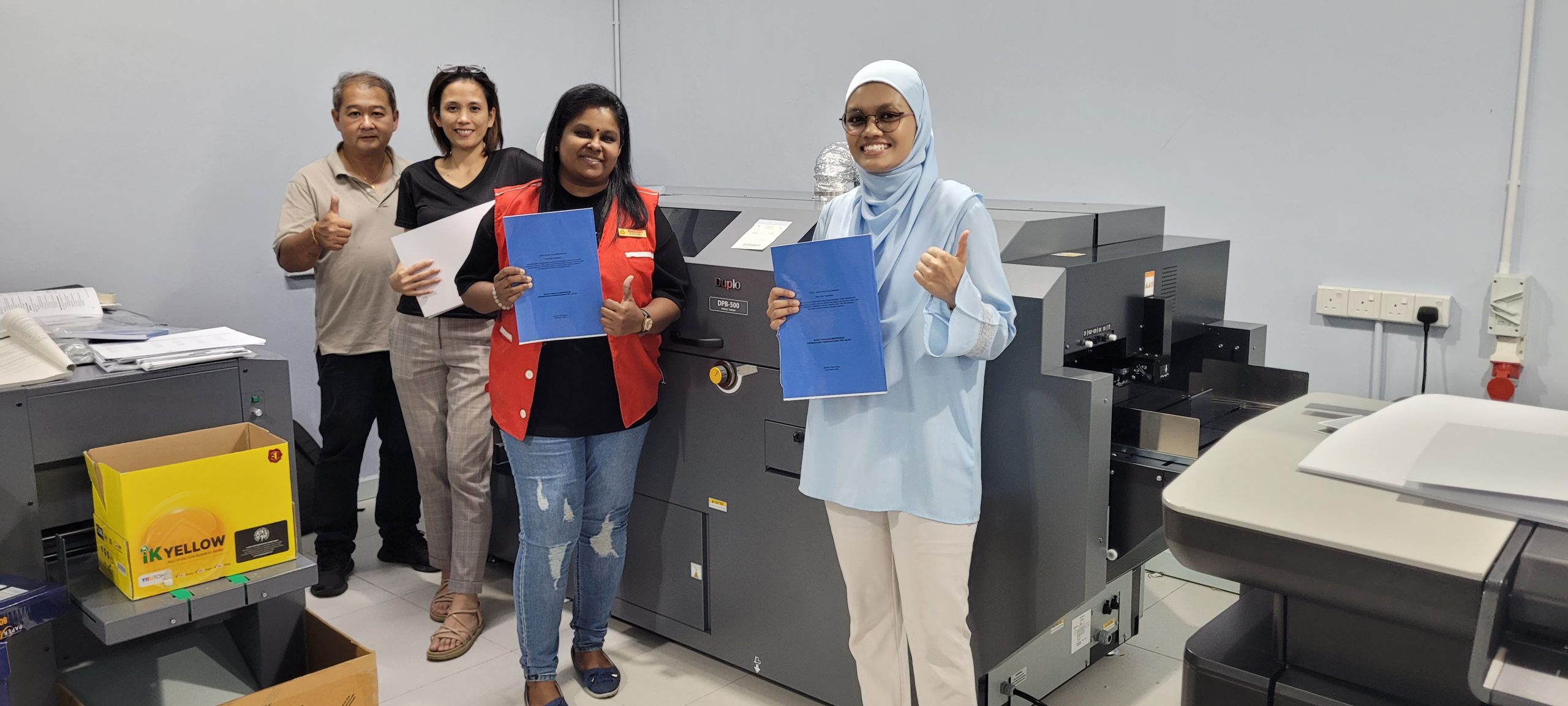 Happy staff with new machine installed.